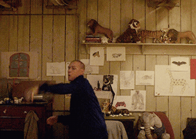 Man In Room With Stuffed Animals GIF