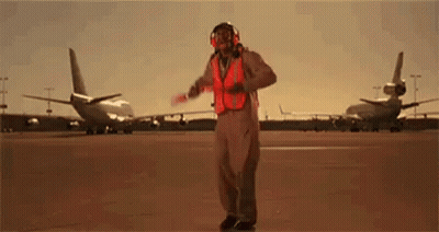 Man In Safety Vest Holding Red Baton GIF