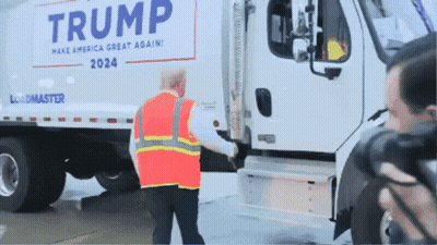 Man In Safety Vest In Front Of Trump Truck GIF
