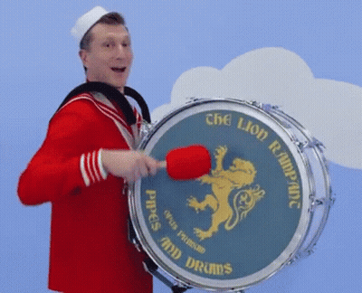 Man In Sailor Costume Playing Drum Saying Pipes And Drums GIF