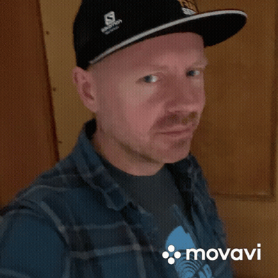 Man In Salomon Hat Plaid Shirt Smiles GIF