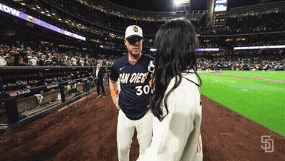 Man In San Diego Jersey Talking To Woman GIF