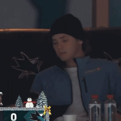 Man In San Jose Sharks Jacket Looking At Phone GIF