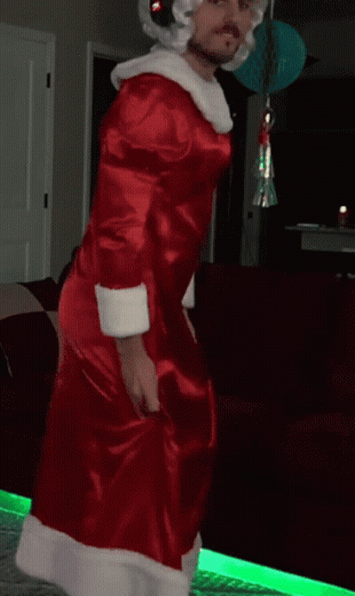 Man In Santa Costume Dancing In Front Of Couch GIF