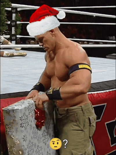 Man In Santa Hat Opening Gift GIF