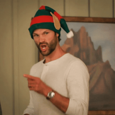 Man In Santa Hat Pointing GIF