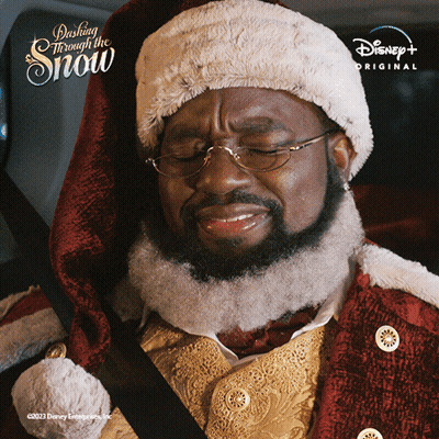 Man in Santa Hat Sitting in Car With Disney+ Logo