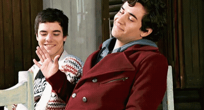 Man In Santa Suit Laying In Snow With Arms Outstretched GIF
