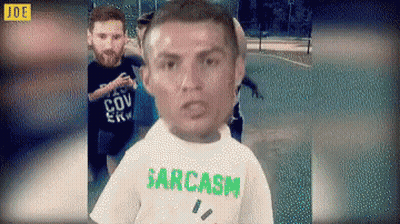 Man In Sarcasm T-Shirt Standing In Front Of Group GIF