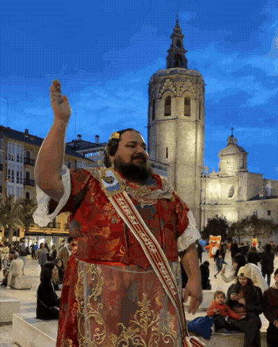 Man In Sash Saying Espana In Front Of Building GIF