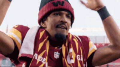 Man In Scarf And Beanie Holding Arms Up GIF