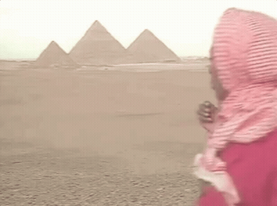 Man In Scarf And Red Shirt At Pyramids GIF