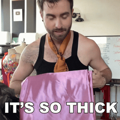 Man In Scarf Holding Pink Cloth Saying It's So Thick GIF