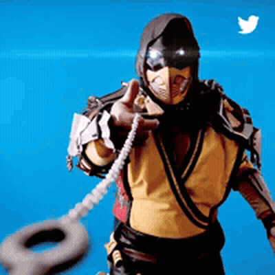 Man In Scorpion Costume Holding Tire Pointing At Camera GIF