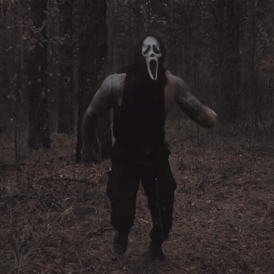 Man In Scream Mask Walking Through Woods GIF