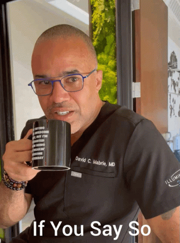 Man In Scrub Top Holding Mug GIF