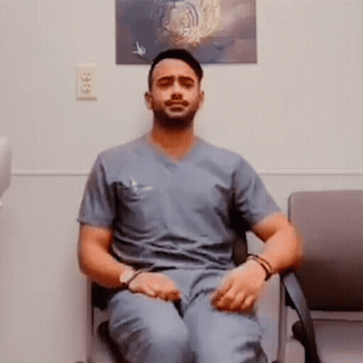 Man In Scrubs Cross-Legged Next To Tiger Picture GIF