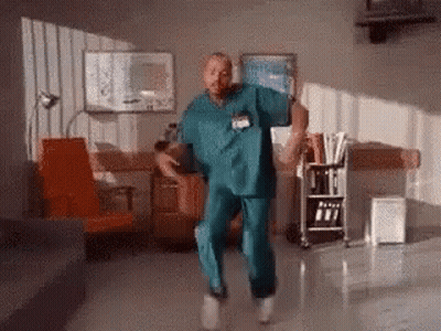 Man In Scrubs Dancing In Hospital Waiting Room GIF