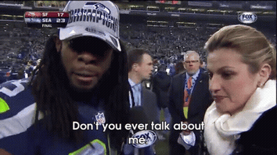 Man In Seahawks Hat Talking To Reporter GIF