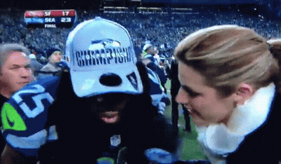 Man In Seahawks Hat Talking To Woman GIF