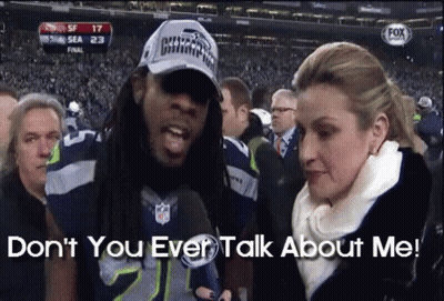 Man In Seahawks Hat With Woman Saying Don't You Ever Talk About Me GIF