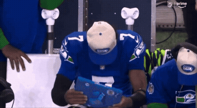 Man In Seahawks Jersey Looking At Tablet GIF