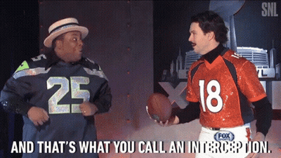 Man In Seahawks Jersey Talking To Man In Orange Jersey Number 18 GIF