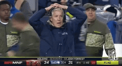 Man In Seahawks Shirt Holding Head GIF