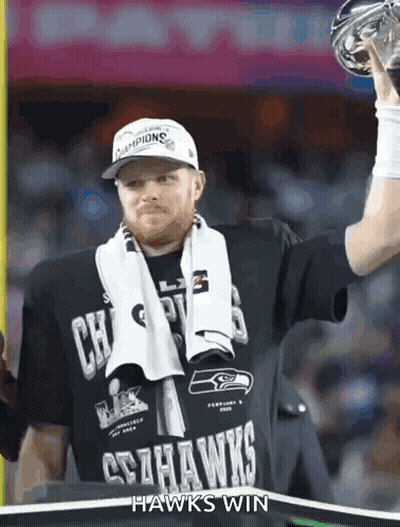 Man In Seahawks Shirt Holding Trophy GIF