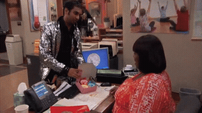 Man In Sequined Jacket Giving Woman Gift GIF