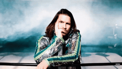 Man In Sequined Jacket Leaning On Railing With Roh GIF