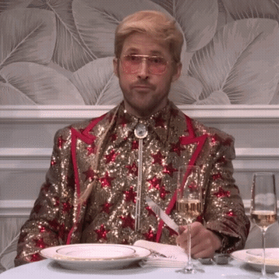 Man In Sequined Suit With Champagne And Plates GIF