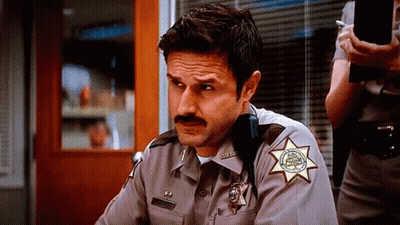 Man In Sheriff's Uniform With Mustache And Star GIF