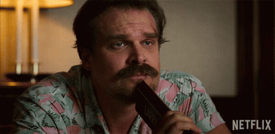 Man In Sheriff Uniform Next To Netflix Logo GIF