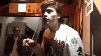 Man In Shirt Saying Supreme On Sleeves GIF
