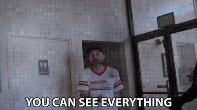 Man In Shirt Saying You Can See Everything In Hallway GIF