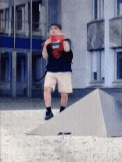 Man In Shorts And Backpack On Concrete Ramp GIF