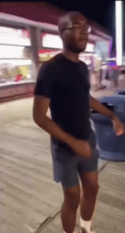 Man In Shorts And Black Shirt Dancing GIF
