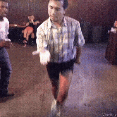 Man In Shorts And Plaid Shirt Dancing GIF
