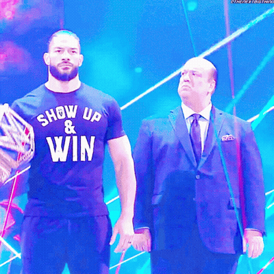Man In Show Up And Win Shirt Next To Another Man GIF