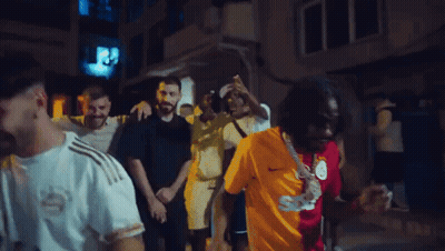 Man In Sigorta Shirt Surrounded By Men GIF
