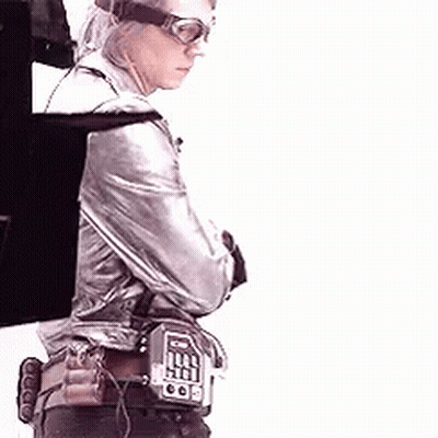 Man In Silver Jacket And Goggles Holding Gun With Arms Crossed GIF