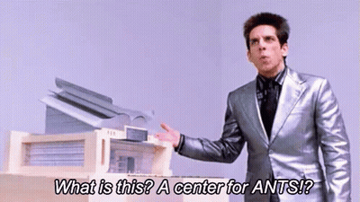 Man In Silver Suit Standing In Front Of Printer GIF