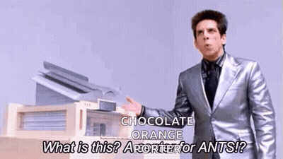 Man In Silver Suit Talking About Chocolate Orange GIF