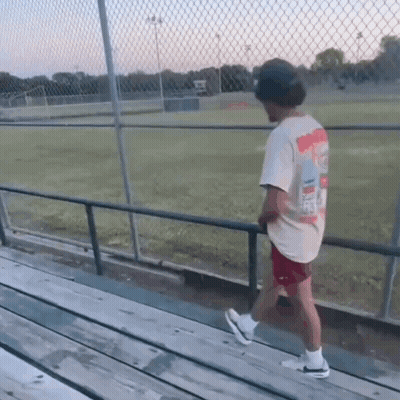 Man In Simpson T-Shirt Walking On Railing GIF