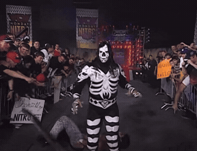 Man In Skeleton Costume Holding Sign Probably Live Nitro GIF