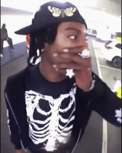 Man In Skeleton Shirt And Hat Smoking GIF