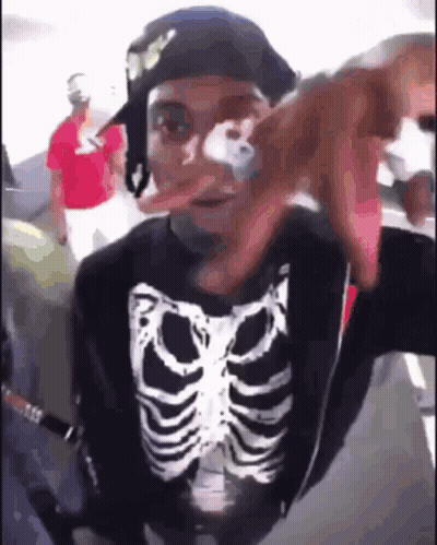 Man In Skeleton Shirt And Hat Taking Selfie On Plane GIF