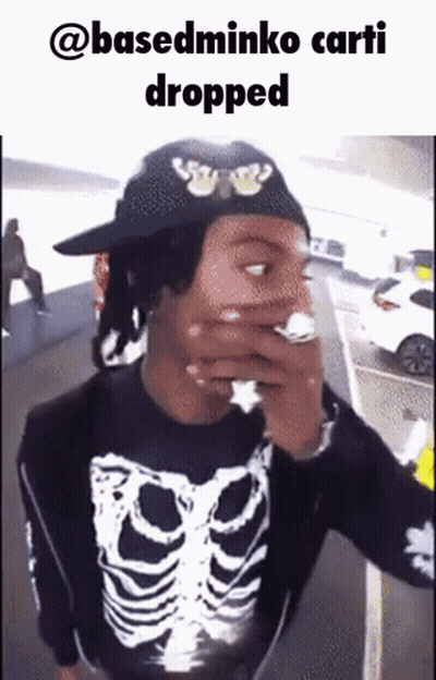 Man In Skeleton Shirt Smoking Cigarette Hat Saying @Basedminko Carti Dropped GIF