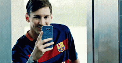 Man In Ski Mask Holding Trophy With Coca Cola Kia Qatar Air Logos GIF